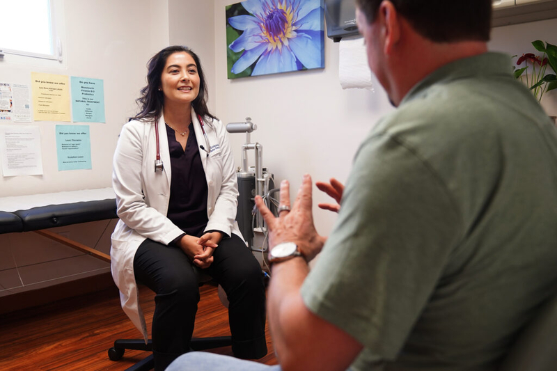 Dr. Krishanna Takemoto-Genitle talks with patient Andres Harnisch in the clinic Thursday, Jan. 29, 2026, in Honolulu. (Kevin Fujii/Civil Beat/2026)