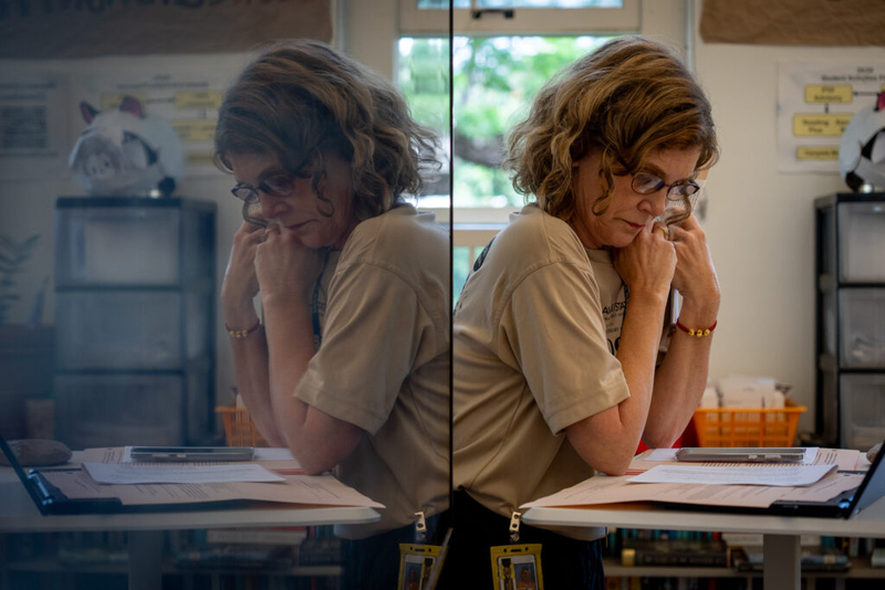 Teacher Cindy Reves is reflected in a monitor during a class using only pencil and paper at McKinley High School May 1, 2026. (Craig Fujii/Civil Beat/2026)