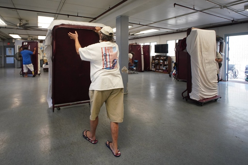 IHS Institute of Human Services beds are moved to the side when the space is used as a cafeteria then converted back to living area for men. The facility is located at 546 Kaaahi Street in Iwilei.