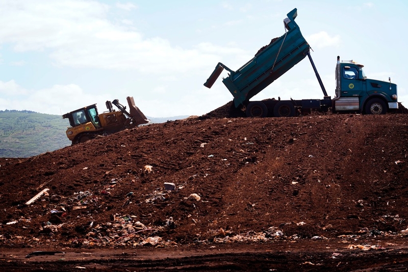A dump truck drops off dirt for County of Kauaʻi workers to spread over rubbish at Kekaha Landfill Friday, June 5, 2026, in Kekaha. (Kevin Fujii/Civil Beat/2026)