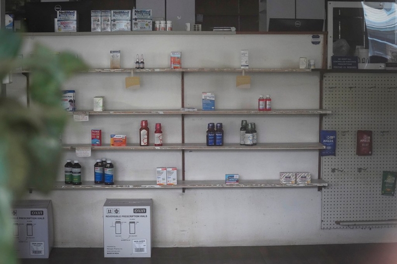 Kohala’s last drug store, Kamehameha Pharmacy, is photographed with doors locked, shelves relatively depleted and lights off Thursday, June 18, 2026, in Kapaʻau. The pharmacist of Hawaiʻi Island’s rural north shore drug store is retiring. (Kevin Fujii/Civil Beat/2026)