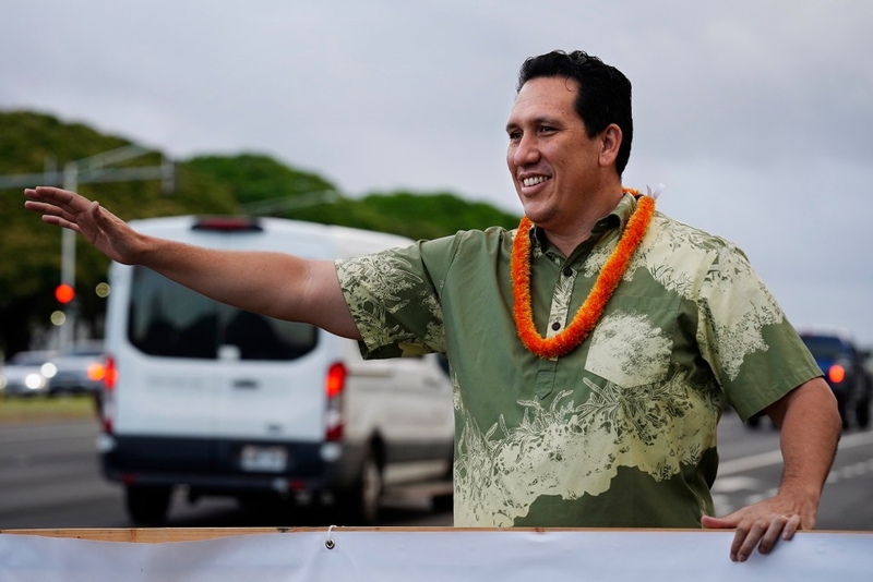 Hawaiʻi state Senator Jarrett Keohokalole waves to drivers on Fort Weaver Road on their morning commute Thursday, June 25, 2026, in ʻEwa Beach. Sen. Keohokalole is running against incumbent U.S. Rep. Ed Case. (Kevin Fujii/Civil Beat/2026)
