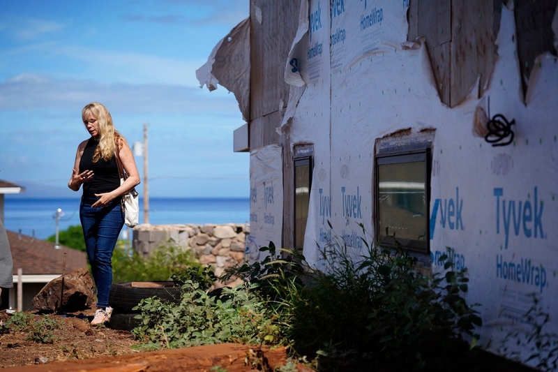 Krista Woodward points out below-standard workmanship  at her stalled home reconstruction Wednesday, July 1, 2026, in Lahaina. Woodward’s contractor allegedly scammed her and others rebuilding in Lahaina. (Kevin Fujii/Civil Beat/2026)