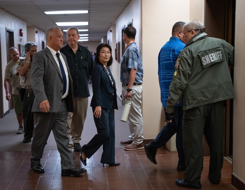 Lt. Gov. Sylvia Luke, facing camera center, leaves her arraignment with her attorney and security detail at Kaʻahumanu Hale July 30, 2026.