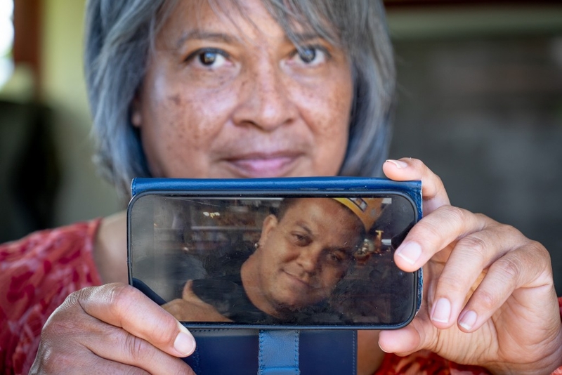 Rhonda Valera lost her partner, John Nobriga, to the toxic effects of methamphetamines in February 2025. She was photographed at her family home holding a photo of John, aka "Smallman," in Mililani August 7, 2026. (Craig Fujii/Civil Beat/2026)
