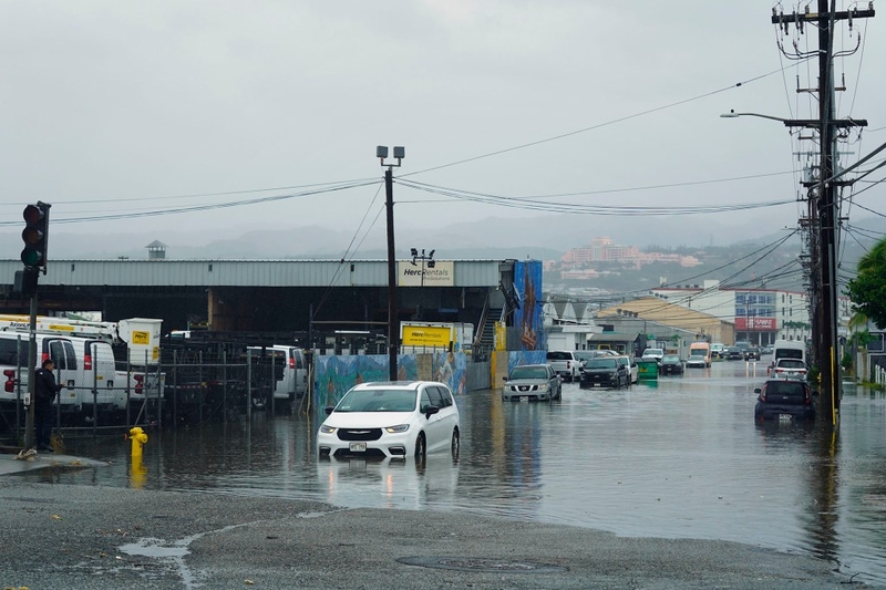 A van is stranded in deep water on Ahua Street mauka of Kilihau Street after Tropical Storm Lala’s wind and rain cause disruptions Sunday, Aug. 16, 2026, in Honolulu’s Mapunpuna neighborhood. The storm reaches O‘ahu after being downgraded from a hurricane. It passed closely to Hawai‘i Island. (Kevin Fujii/Civil Beat/2026)