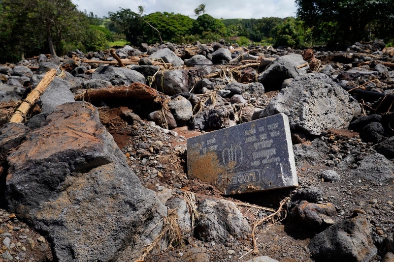 A headstone from the Nāʻālehu Cemetery lies among rubble Tuesday, Aug. 18, 2026, on Hawaiʻi Island. Hurricane Lala made a close pass to the South Point of the Big Island Saturday. (Kevin Fujii/Civil Beat/2026)