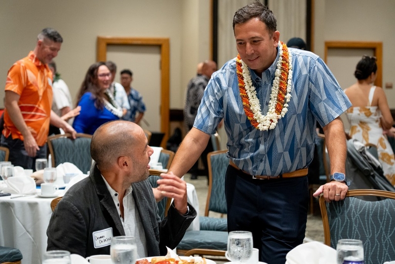 District IV Democratic primary winner Trevor Ozawa, right, speaks with state Sen. Donovan Dela Cruz at the party's Unity Breakfast in Honolulu, August 8, 2026.