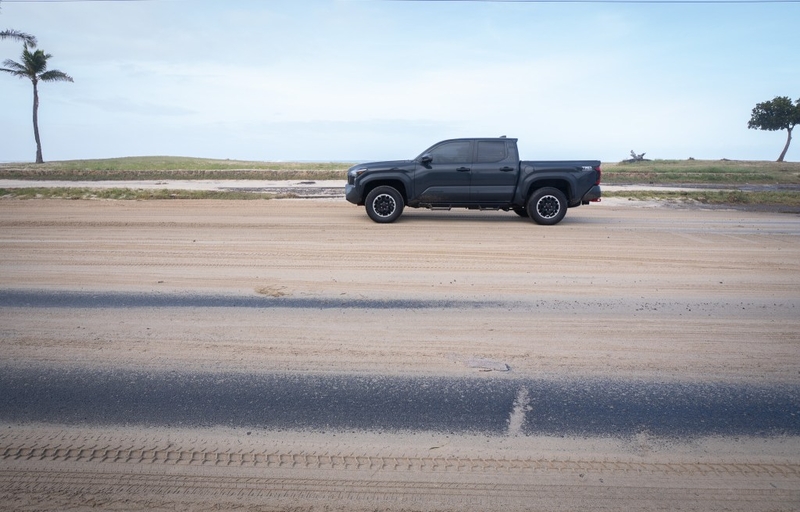 Sand covered portions of Farrington Highway Sept. 8, 2026. Hurricane Lowell pushed sand onto the thoroughfare overnight. (Craig Fujii/Civil Beat/2026)