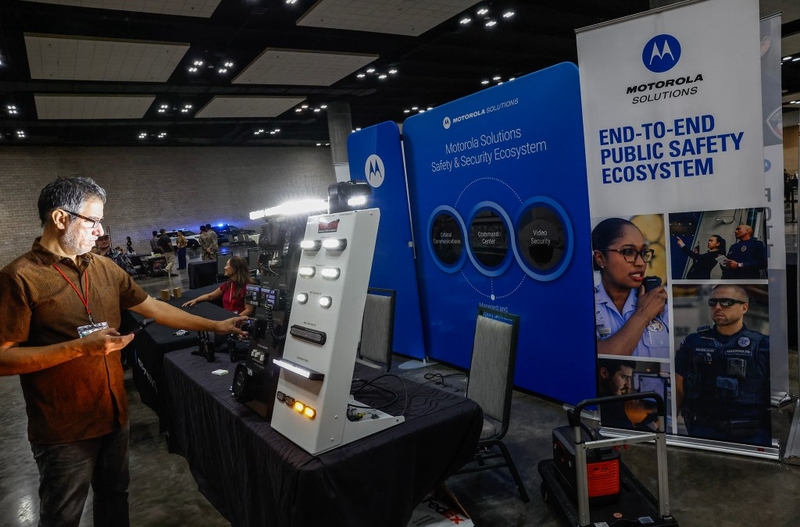 Participants explore the latest tech and equipment, including law enforcement vehicle lighting systems by Motorola, during the Dept. of Law Enforcement’s Public Safety Expo, Saturday, Sept. 26, 2026, at the Hawaiʻi Convention Center in Honolulu.  (Jamm Aquino/Civil Beat/2026)
