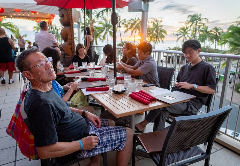 Masataka Yokoyama, left, and his son, Masaki, right, have a meal with relatives in Waikīkī Sept 11, 2026. The two were visiting from Japan to attend a wedding. (Craig Fujii/Civil Beat/2026)