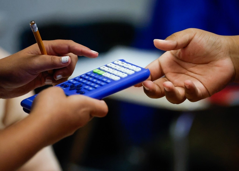 Sixth-graders share a calculator during math class at Kūlia Academy, Wednesday, Sept. 30, 2026, in Kalihi.  Kūlia Academy’s middle school math achievement has had unprecedented improvement, and had the highest middle school math scores in the state last year. (Jamm Aquino/Civil Beat/2026)