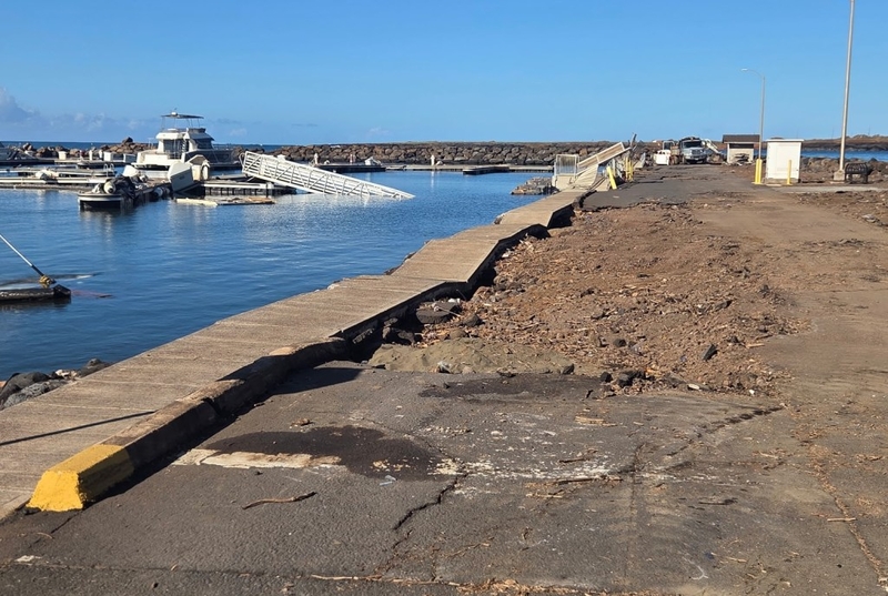 A crumbled concrete walkway and a road with a missing chunk of asphalt at Port Allen Harbor in ‘Ele‘ele on Kaua‘i.