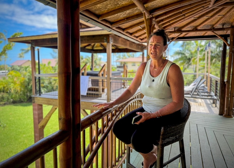 Wainiha resident Megan Wong sits at one of her vacation rentals, Friday, Sept. 11, 2026, in Wainiha on Kauaʻi. Wong  has been going door to door helping residents of the North Shore community.  (Nathan Eagle/Civil Beat/2026)