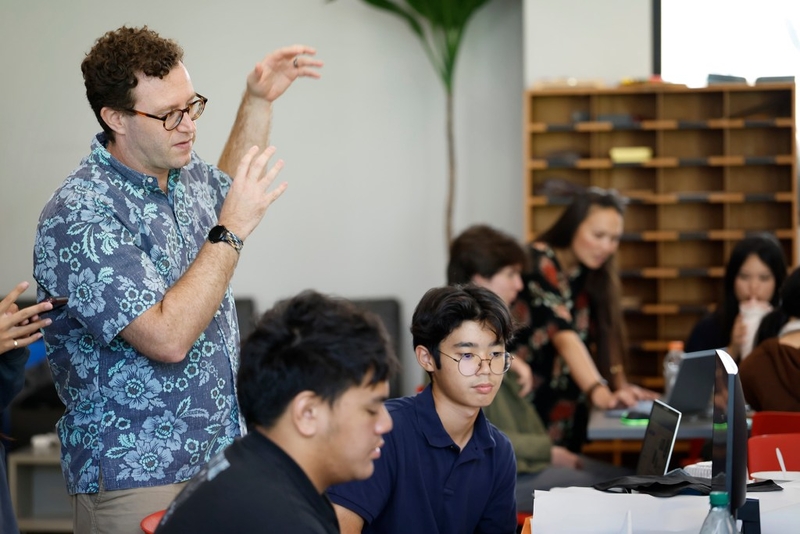 Nalukai program facilitator Auston Stewart, left, works with Hawaiʻi Island teens Thursday, Oct. 8, 2026, in Hilo. They spend the week learning how to identify and solve problems in their communities. (Kevin Fujii/Civil Beat/2026)