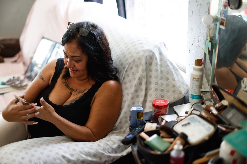 Kēhau Manijo cries while going through photos of herself and Tommy Manijo at her residence, Friday, Oct. 2, 2026, in Waiʻanae.  (Jamm Aquino/Civil Beat/2026)