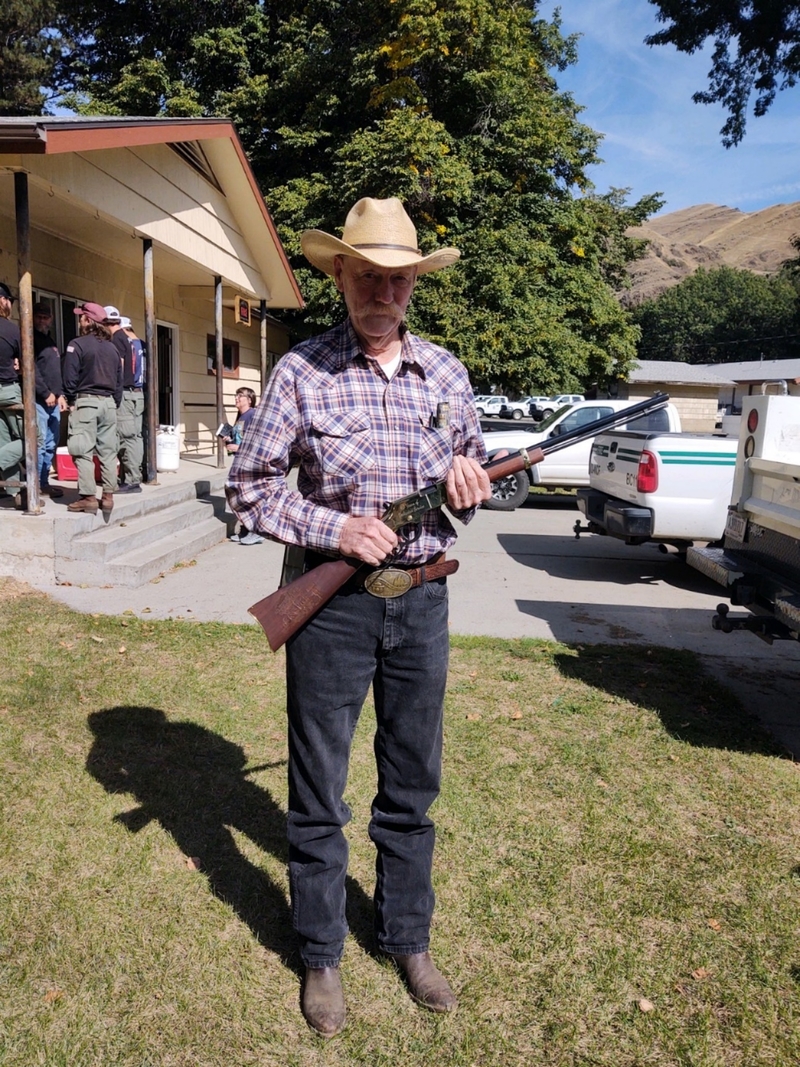 Dutcher stands with his custom engraved Henry Golden Boy .22 MAG rifle