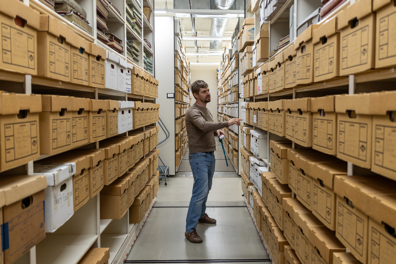 Idaho State Historical Society Reference Archivist Owen Prout walks between shelves of historical records in the agency's vault.