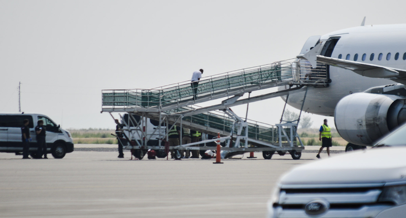 An ICE detainee climbs a ramp onto a plane on Aug. 11, 2026, at the Magic Valley Regional Airport.