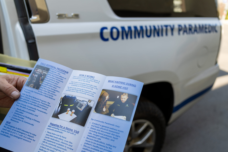 An Ada County community paramedic holds up a pamphlet explaining what home visits from community paramedics look like.