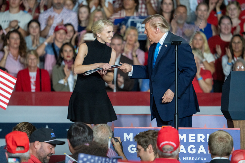 President Donald Trump hands off a newly signed executive order waiving federal taxes on red-dyed diesel