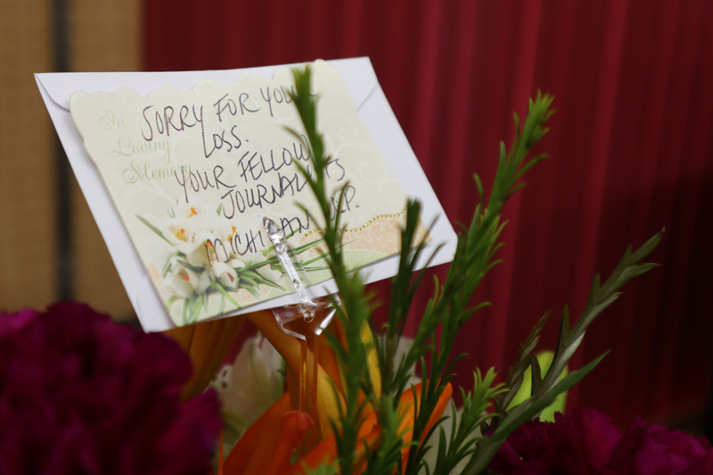 Flowers in the newsroom of the Marion County Record on Wednesday from fellow journalists offer sympathy for the death of co-owner Joan Meyer.