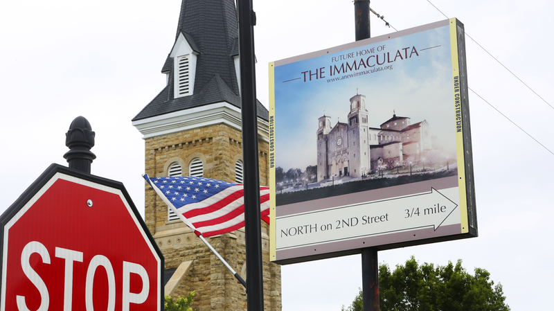 A sign in the center of St. Marys advertises the location of the Immaculata, a towering structure just a few streets away. (Thad Allton for Kansas Reflector)