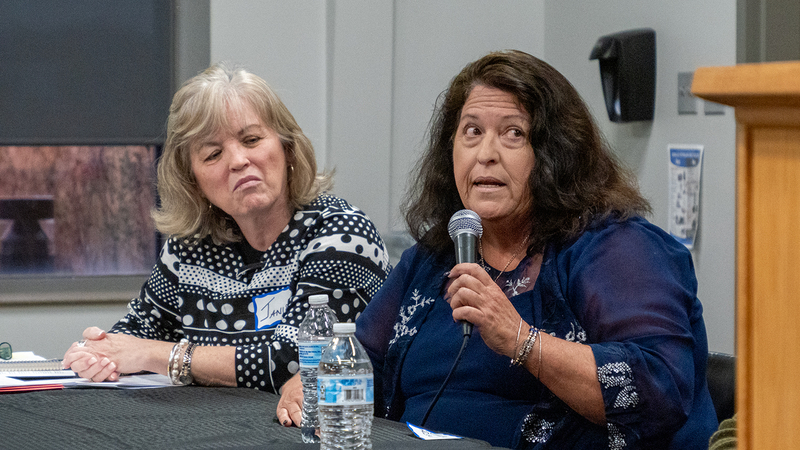 Janis DeBoer, left, listens as Camille Russell speaks during the Nov. 12, 2024, forum hosted by Kansas Advocates for Better Care at Baker Wetlands Discovery Center