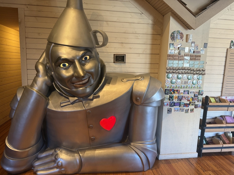 Inside the Oz Museum, a larger-than-life Tin Man with an illuminated heart greets visitors.