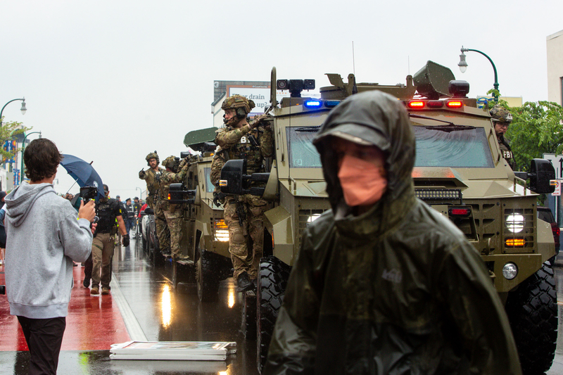 Federal officers on June 3, 2025, drive down Lake Street in Minneapolis, Minnesota, as ICE, other federal officers, Minneapolis police, and state officers raid Las Cuatro Milpas