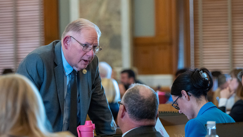 House Speaker Dan Hawkins, R-Wichita, talks with colleagues during the Jan. 28, 2026, debate on anti-trans legislation in the House.
