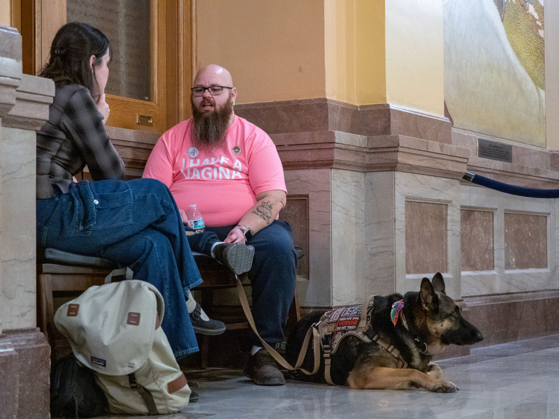 Matthew Neumann speaks to Kansas Reflector reporter Anna Kaminski on Feb. 6, 2026, at the Statehouse. He is executive director of the LGBTQ Foundation of Kansas