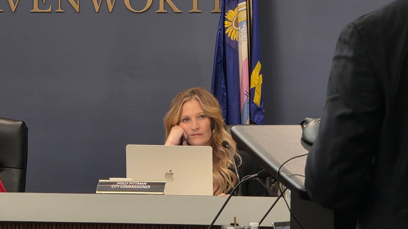Leavenworth City Commissioner Holly Pittman listens to a CoreCivic official during a Feb. 25, 2026, hearing on the company's special use permit. If approved, the permit allows the Nashville-based company to reopen its prison to house immigration detainees.