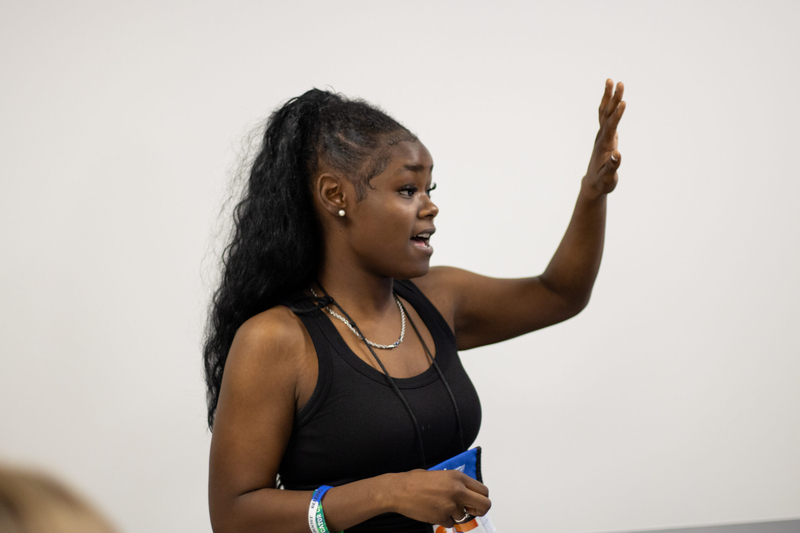 A girl raises her hand in a classroom