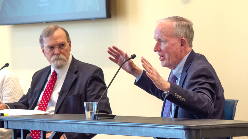 Former Gov. John Carlin, right, gestures while former Kansas Supreme Court Chief Justice Lawton Nuss listens during a June 16, 2026, forum at Washburn University in Topeka