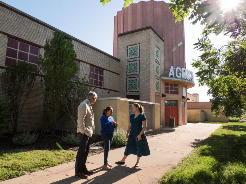 From left, Kansas Legal Services executive director Matt Keenan, Mariana Villegas, and KLS staff attorney Katie King speak after a court hearing on May 12, 2026, outside of the Agricultural Hall, which sits in the shadow of the Stormont Vail Events Center in Topeka