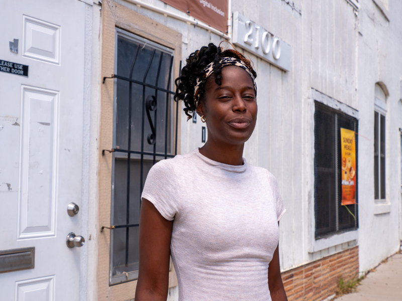 Nikki Richardson-Iwegbu stands in front of a white building