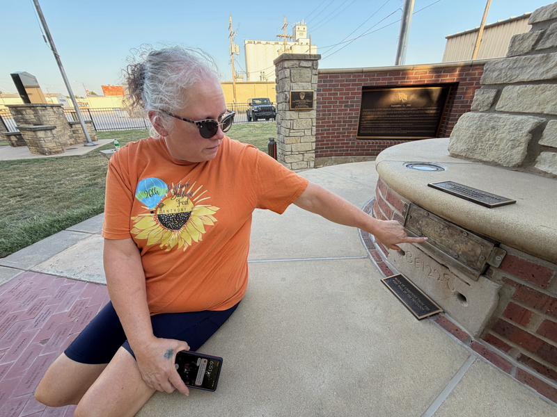 Donna Crowe, a lifelong resident of Anthony, points to soil from the Flight 93 crash site, as incorporated into the town's 9/11 memorial. Below the soil is a brick from the Pentagon. Crowe was chair of the committee that established the memorial.