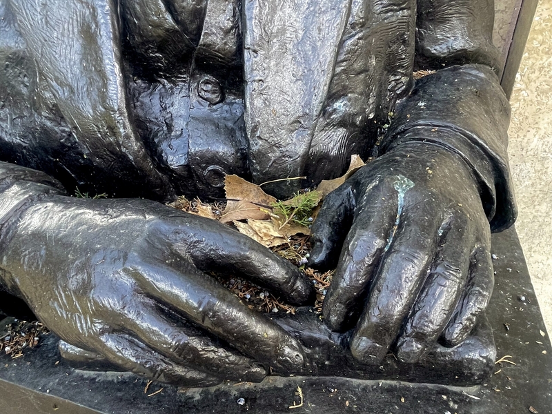 William Allen White's hands, cast in bronze, cradle leaf debris at Emporia's Peter Pan Park.