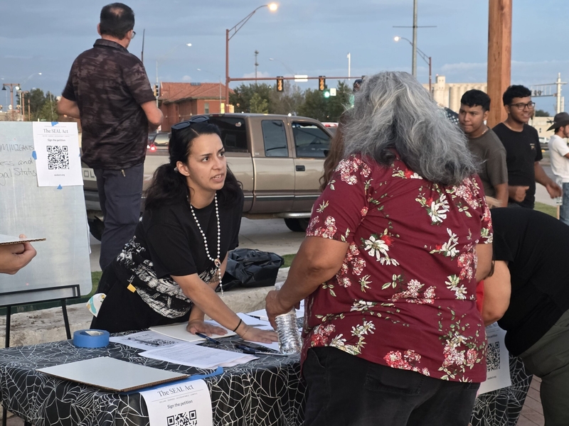 Julysa Barraza, a local activist, explains a petition for the SEAL Act, which would create a clear path for immigrants to become U.S. citizens, during a rally on Sept. 24, 2026, in Dodge City.