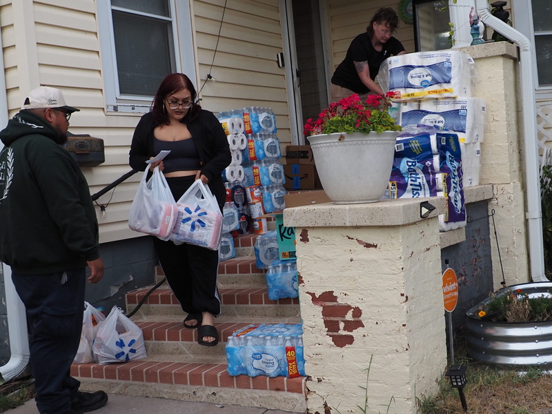 Volunteers Aquilino Reyes, left, Amy Soberanes, center, and Anna Meyer load supplies Sept. 24, 2026, that were donated to Dodge City immigrants afraid to leave their homes while U.S. Immigration and Customs Enforcement agents were in town.