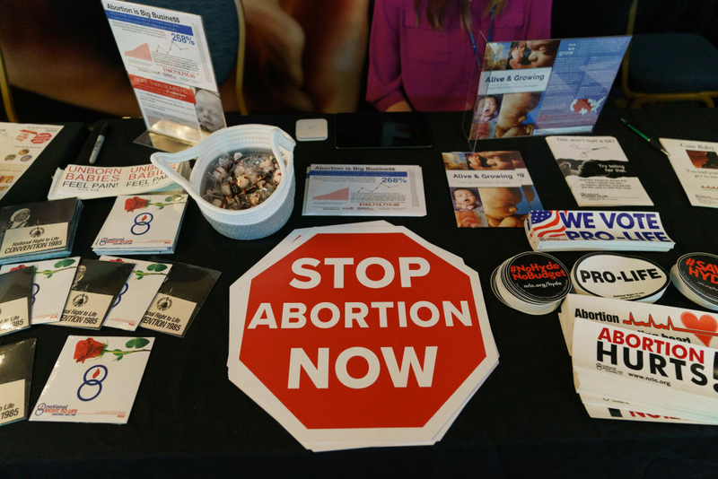 Anti-abortion stickers are placed on a table.
