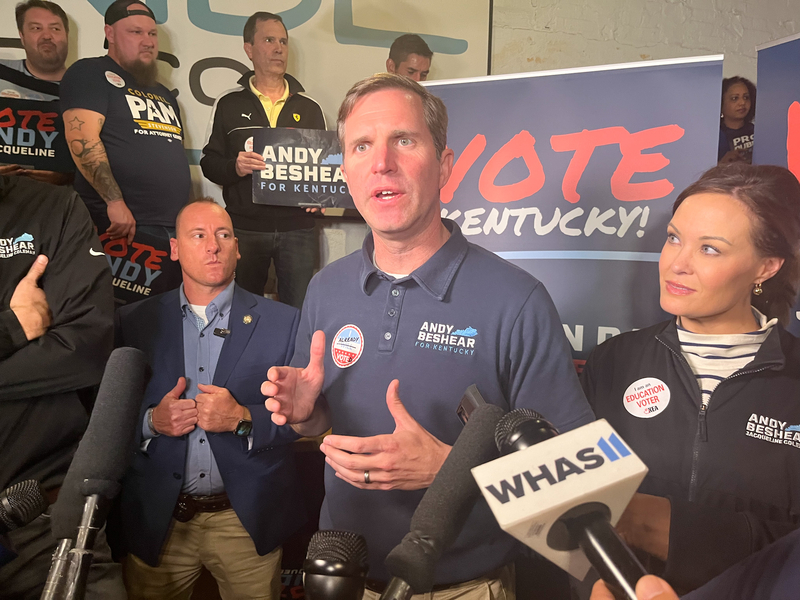 Gov. Andy Beshear talks to reporters after his Louisville rally Monday night, Nov. 6, 2023. Lt. Gov. Jacqueline Coleman stands at his side.