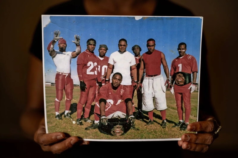 Kentrell Parker, second from left, poses in 2010 with teammates from the East Yard Raiders in a photograph held by his mother.