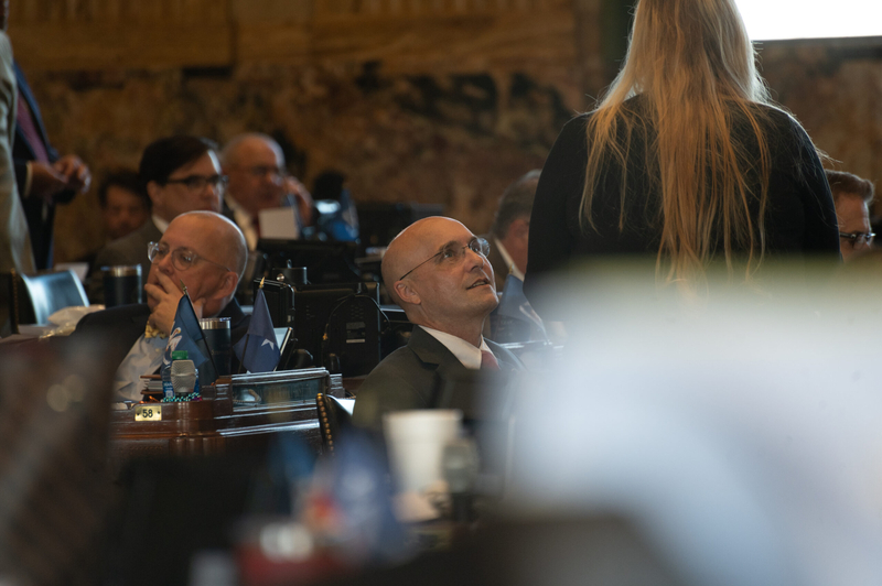 Rep. Wright looks up at a women standing near him.