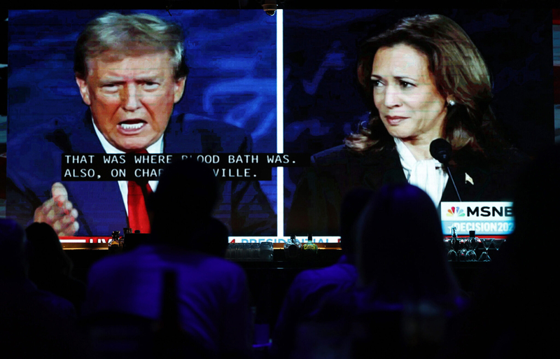 People watch the ABC News presidential debate between Democratic nominee, U.S. Vice President Kamala Harris, and Republican nominee, former U.S. President Donald Trump, on Tuesday, Sept. 10, 2024, at a watch party at The Abbey, a historic gay bar in West Hollywood, California.