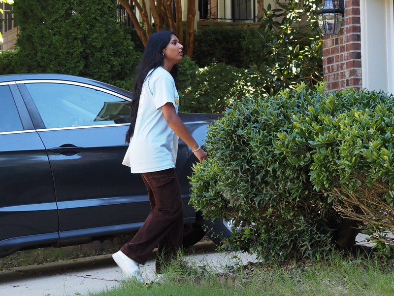 Eva Eapen, 18, asks a resident if she is registered to vote and if she wants a pamphlet of information about the candidates in the upcoming election, on Sept. 28 in the Chapel Hill, North Carolina, area.