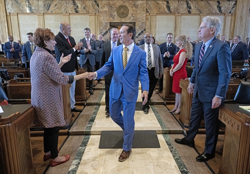 Louisiana Gov. Jeff Landry, center, greets Rep. Polly Thomas, R-Metairie, left, with Rep. Mike Johnson, R-Pineville, to the right, as he enters the Louisiana House of Representatives