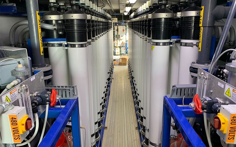 Tall, cylindrical tanks are part of a reverse osmosis system inside a semi trailer.