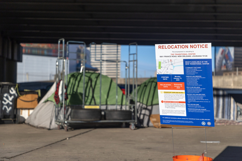 A relocation notice posted in front of a makeshift shelter at the Earhart encampment